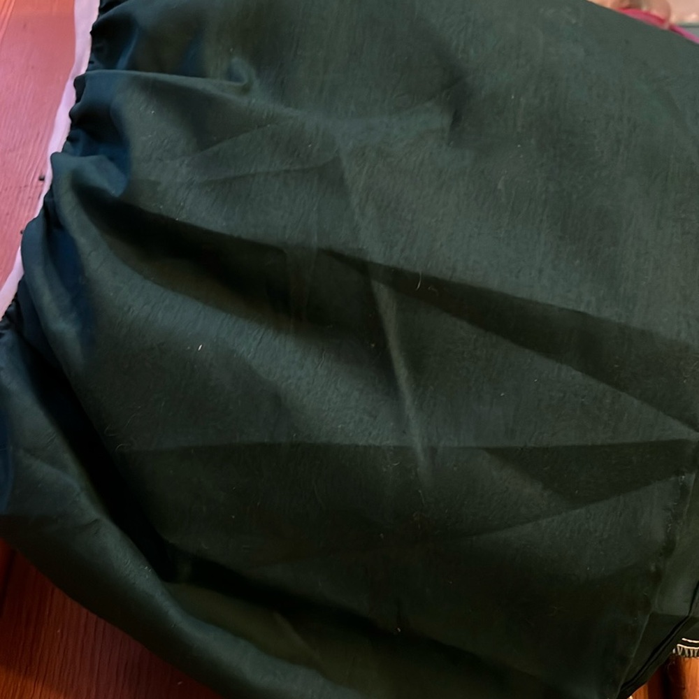 Queen size dust ruffle in dark green.
